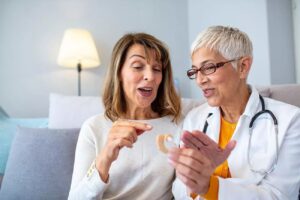 Adults discussing how to clean a hearing aid